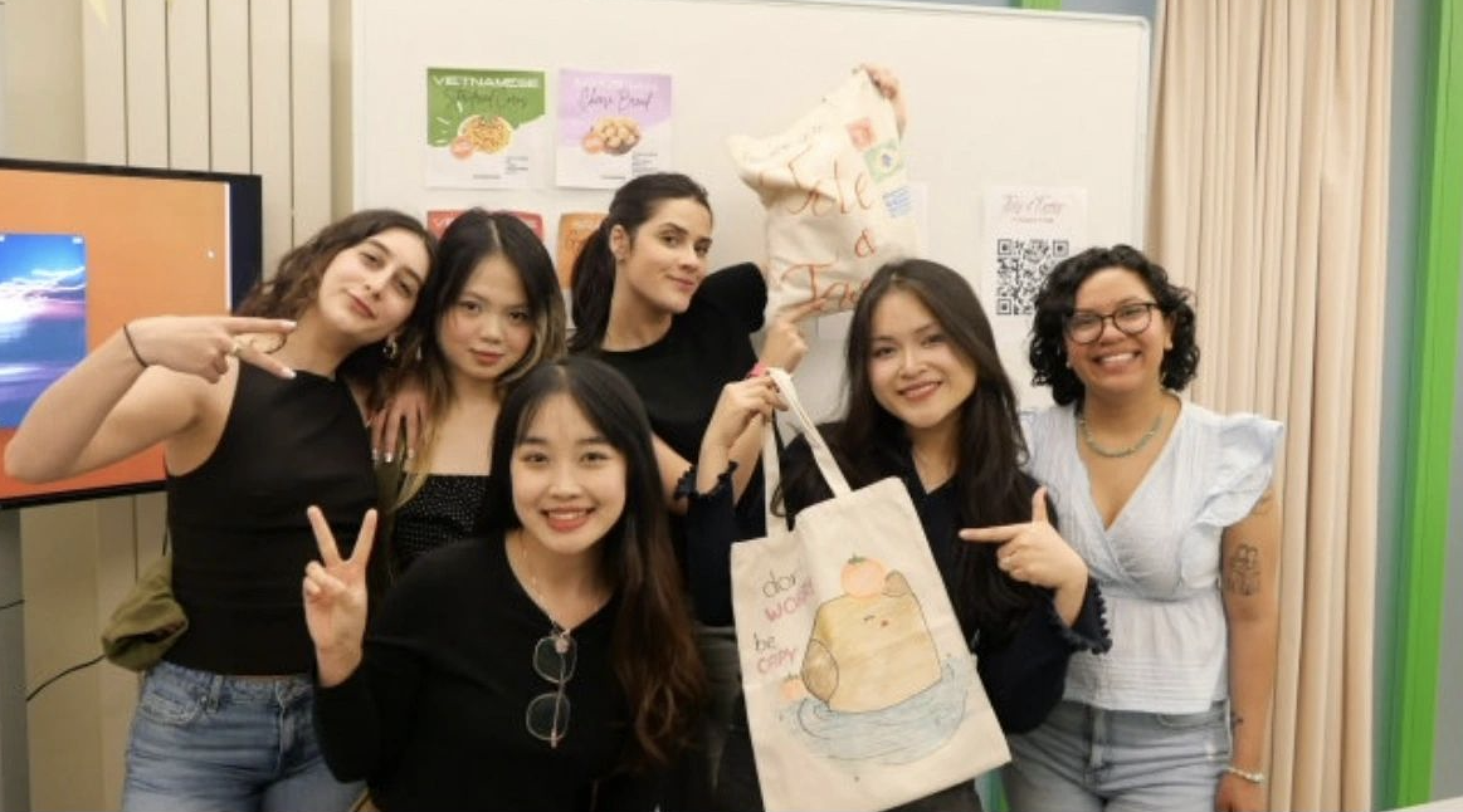 Team members with their painted Tote & Taste tote bags